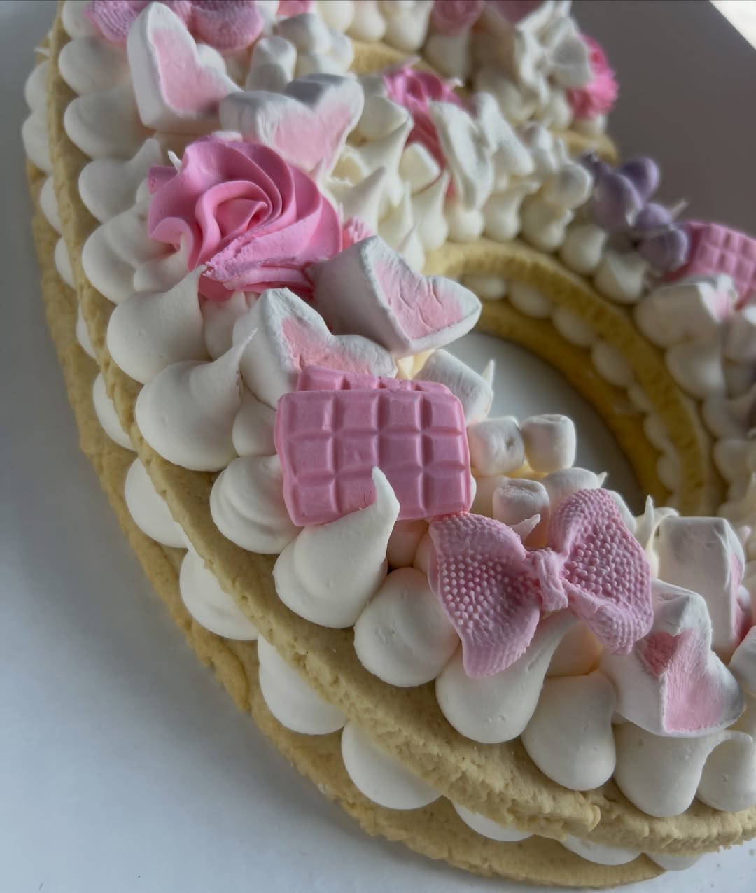 Close-up of hand-piped buttercream roses on a simcha cake