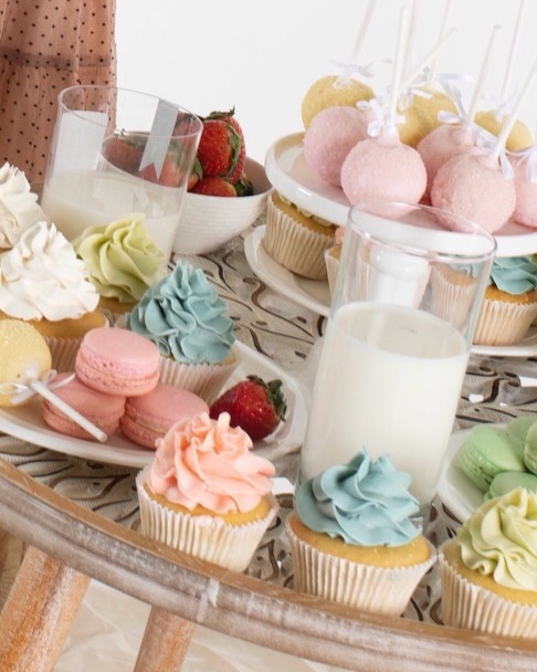 Custom dessert spread with cupcakes, macarons, cake pops, and fresh strawberries